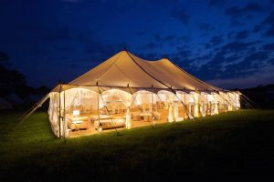 Night-time shot of an illuminated Petal Pole Wedding Marquee 