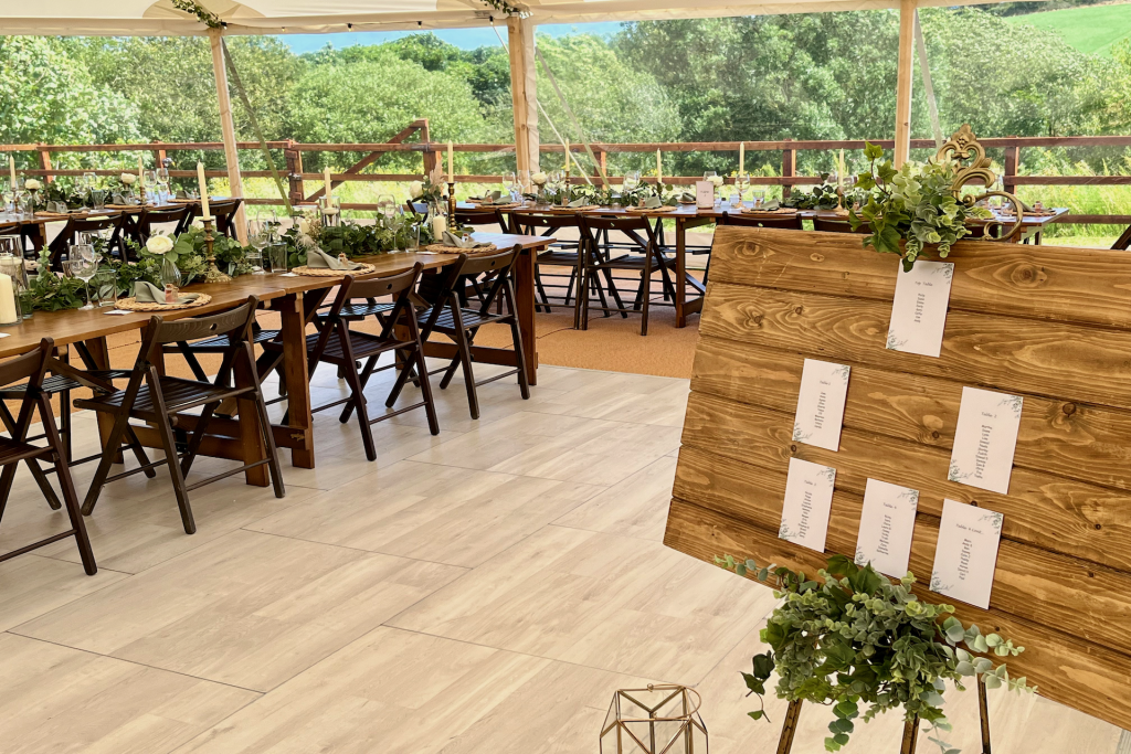 Rustic wooden furniture and a handcrafted board displaying guest names