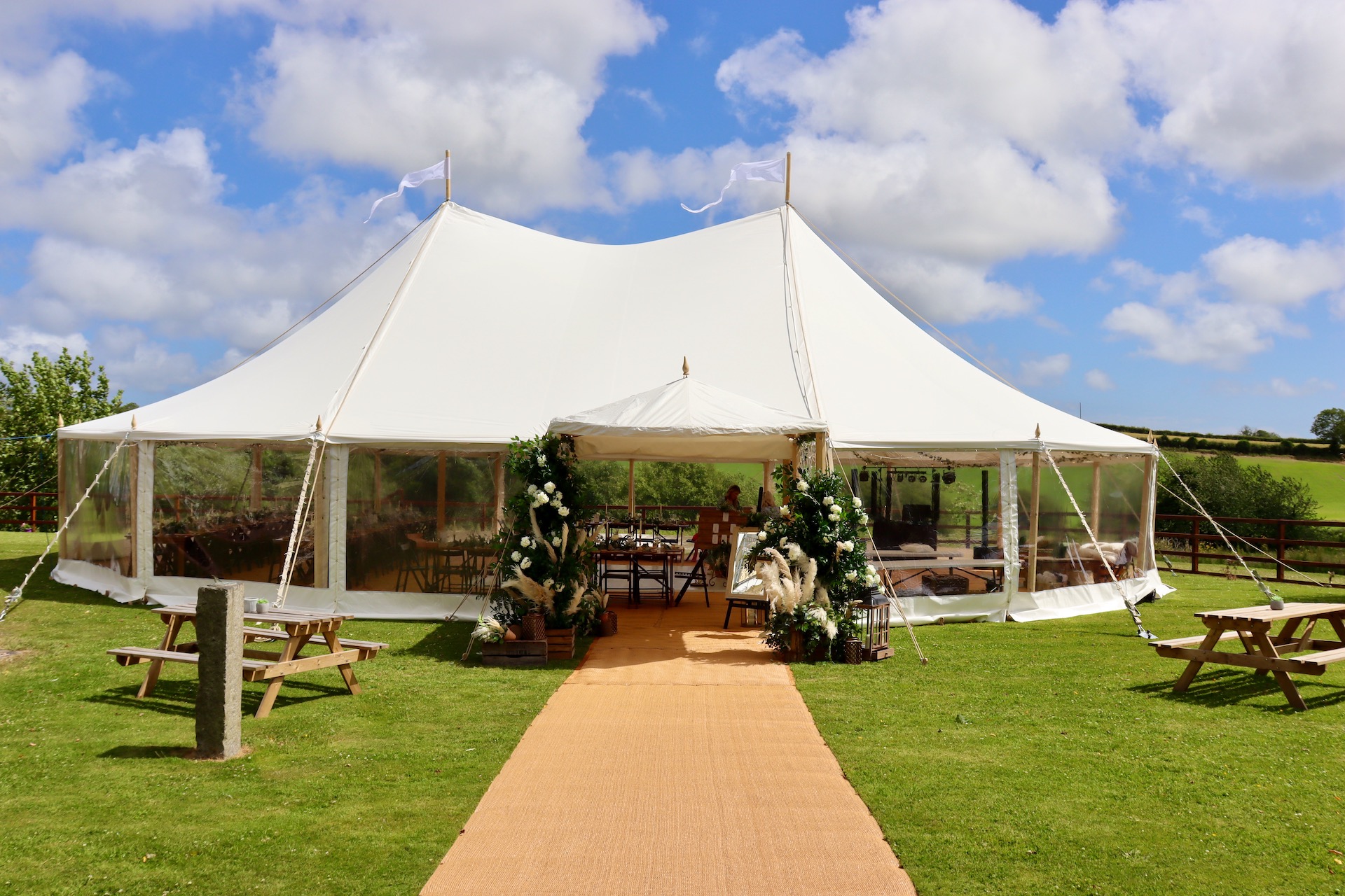 Summer wedding featuring our traditional pole marquee and an entrance canopy