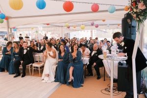 Guests laughing and smiling in a Colourful Wedding Marquee