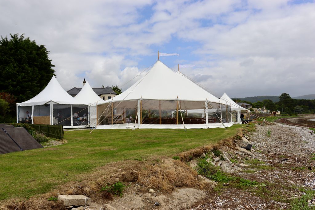Grand traditional pole marquee wedding along the coast