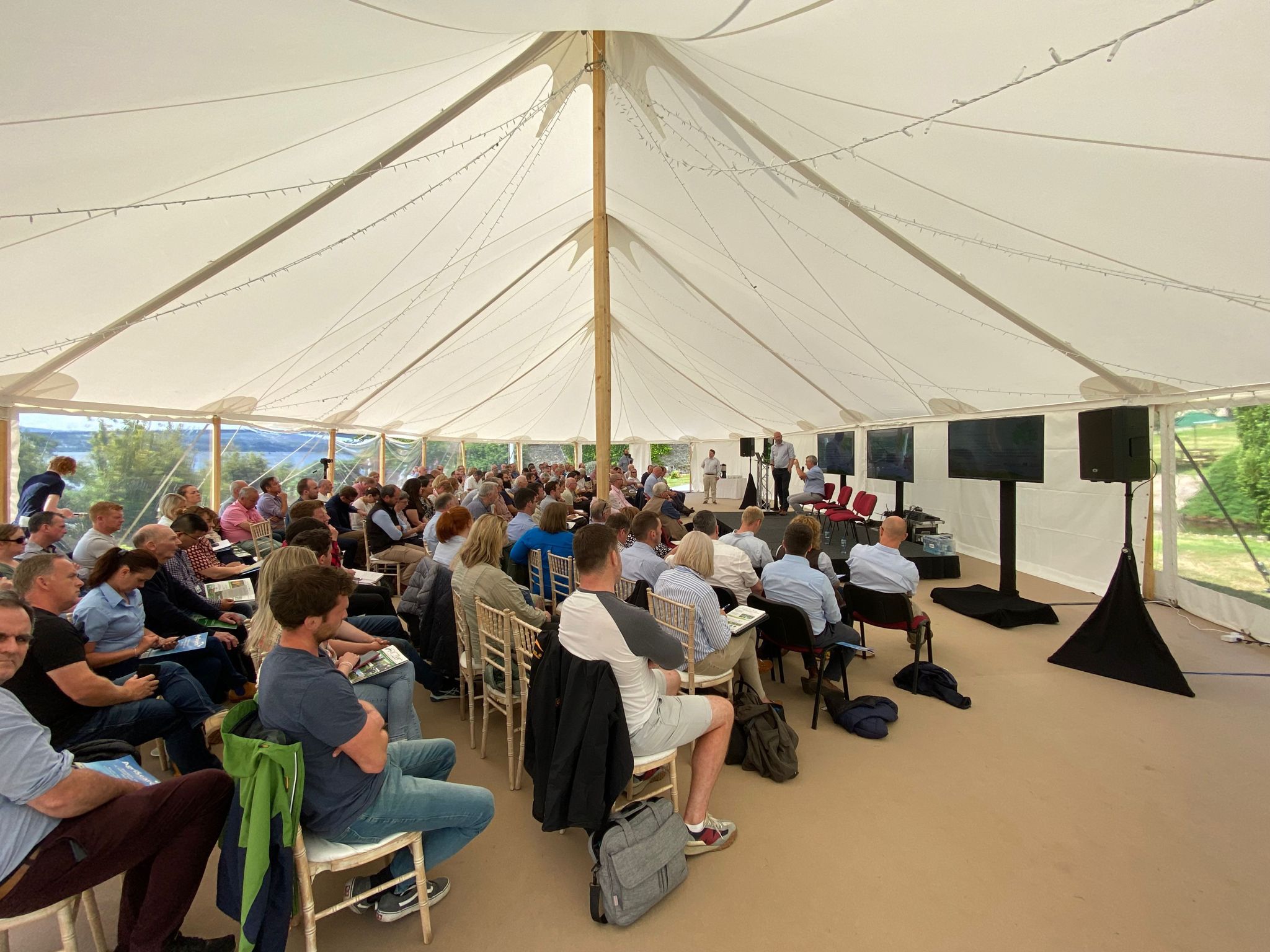 Conference held inside a traditional pole marquee