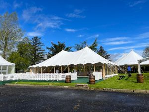 Petal Pole marquee with outdoor decking and white picket fencing