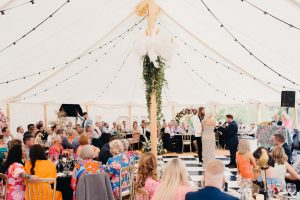 Couple saying vows in an expansive wedding marquee